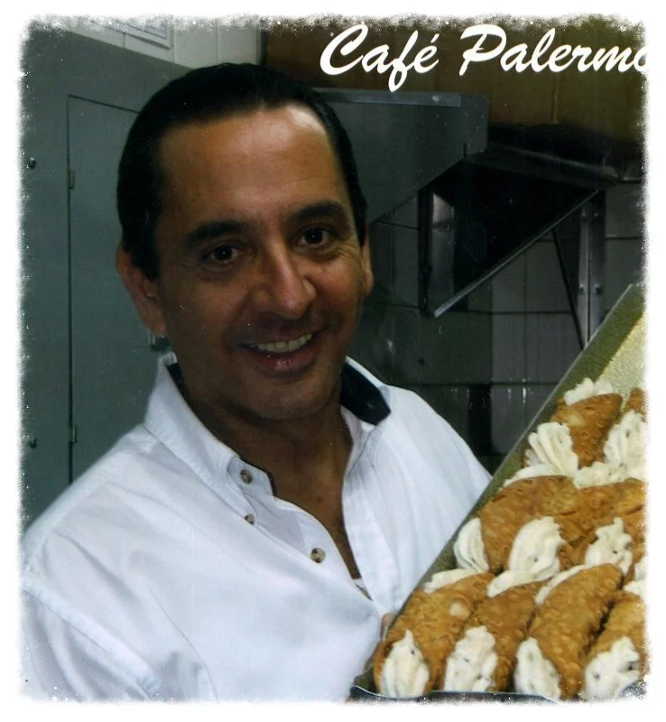 Baby John smiling with a tray of Caffè Palermo cannoli