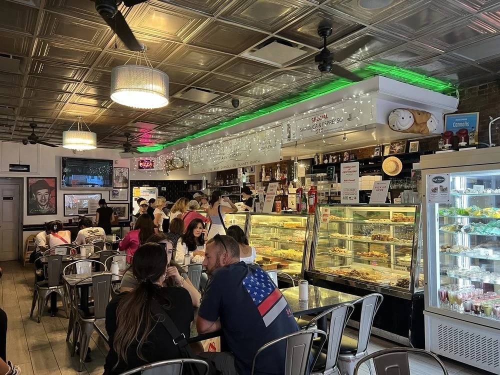 Guests and the pastry counter inside Caffè Palermo